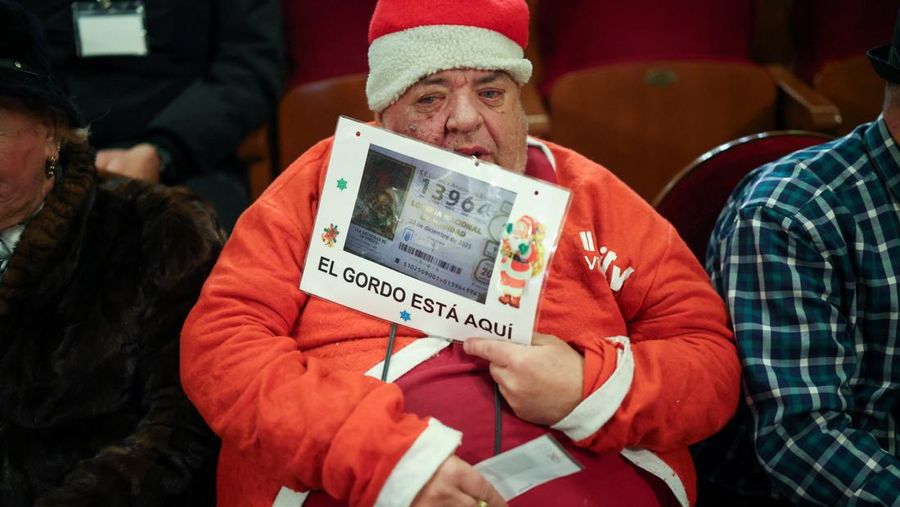 Workers operate the lottery machine, on the day of Spain's Christmas lottery 