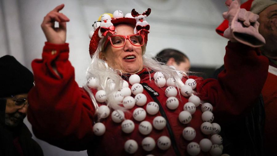 Workers operate the lottery machine, on the day of Spain's Christmas lottery 