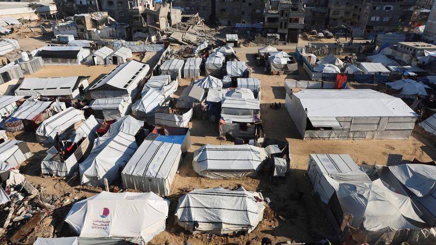 Palestinians pray near the body of baby Saeed Abdeen, who according to the medics died due to cold weather, in Khan Younis, southern Gaza Strip, December 18, 2025. REUTERS/Ramadan Abed