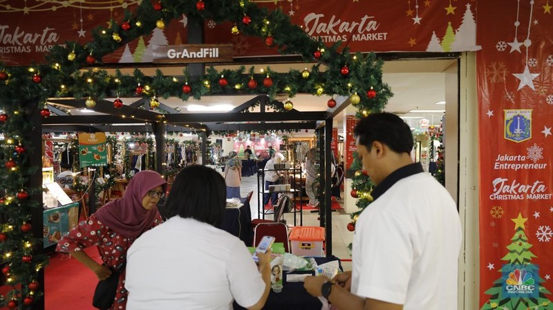 Pengunjung membeli pernak-pernik saat Jakarta Christmas Market 2025 di Blok M Hub, Jakarta, Selasa (23/12/2025). (CNBC Indonesia/Tri Susilo)
