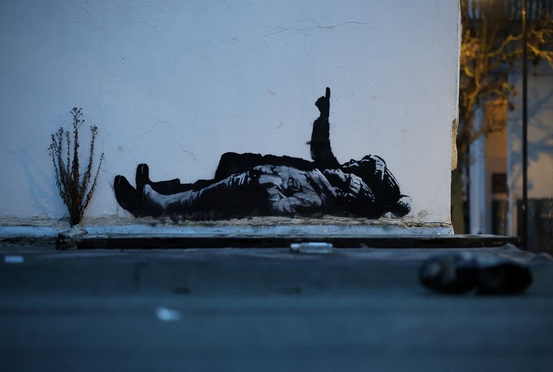 Seseorang berjalan melewati mural baru yang dilaporkan karya seniman anonim Banksy, di Tottenham Court Road, London, Inggris, 22 Desember 2025. (REUTERS/Isabel Infantes)