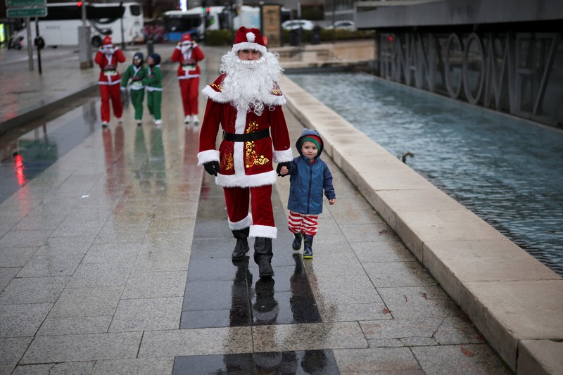 People dressed as Santa Claus ride their motorcycles through Barcelona, Spain, December 21, 2025. REUTERS/ Bruna Casas