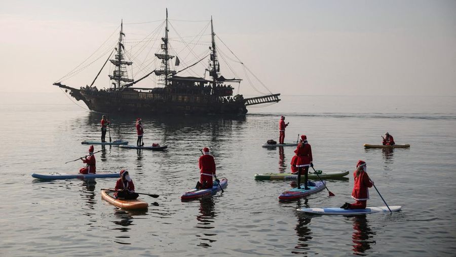 People dressed as Santa Claus ride their motorcycles through Barcelona, Spain, December 21, 2025. REUTERS/ Bruna Casas