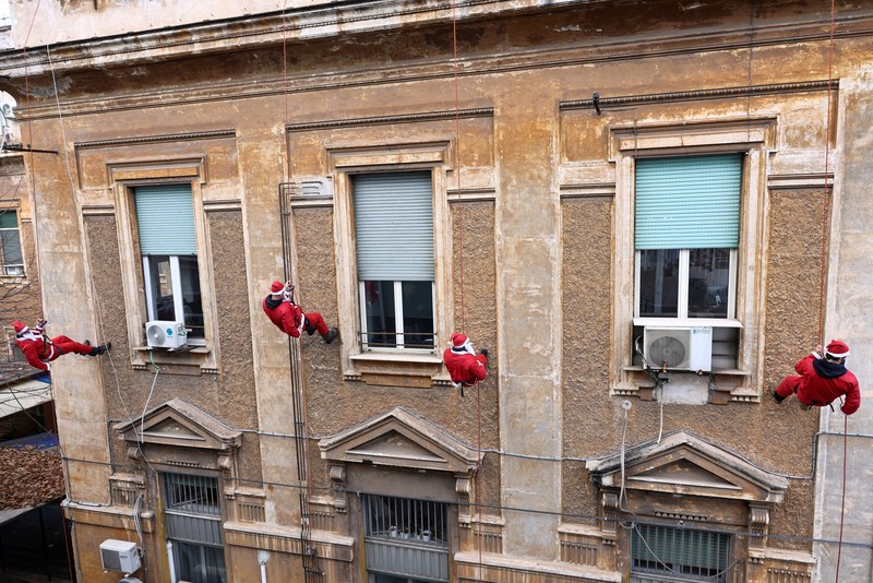 People dressed as Santa Claus ride their motorcycles through Barcelona, Spain, December 21, 2025. REUTERS/ Bruna Casas