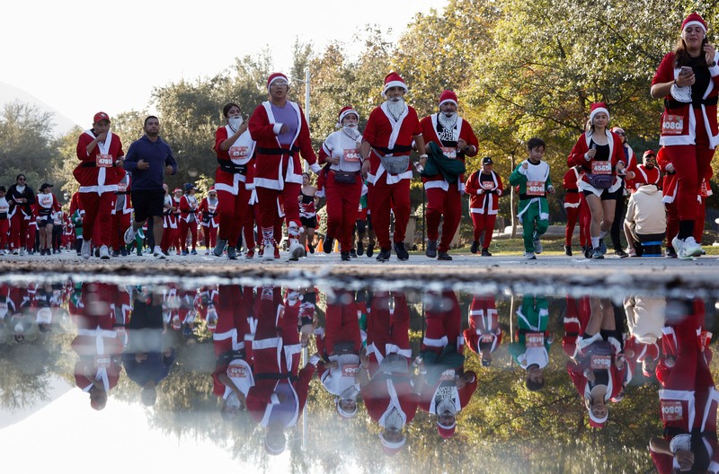 People dressed as Santa Claus ride their motorcycles through Barcelona, Spain, December 21, 2025. REUTERS/ Bruna Casas