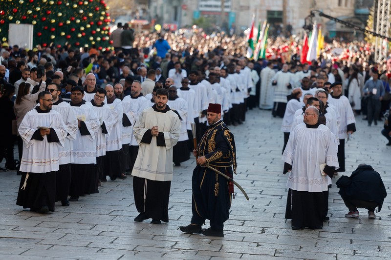 Palestinian scouts parade at Manger Square outside the Church of the Nativity in Bethlehem, in the Israeli-occupied West Bank, on Christmas Eve, December 24, 2025. REUTERS/Ammar Awad