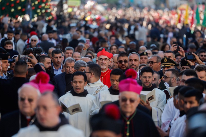 Palestinian scouts parade at Manger Square outside the Church of the Nativity in Bethlehem, in the Israeli-occupied West Bank, on Christmas Eve, December 24, 2025. REUTERS/Ammar Awad