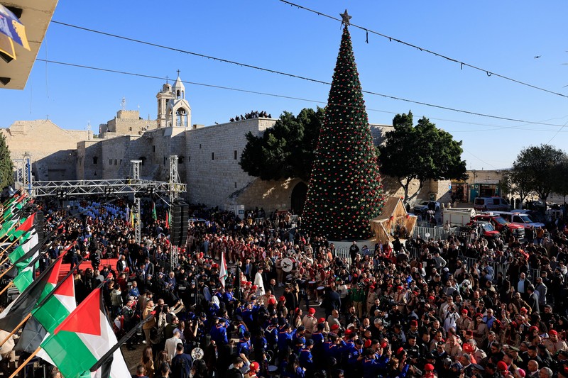 Palestinian scouts parade at Manger Square outside the Church of the Nativity in Bethlehem, in the Israeli-occupied West Bank, on Christmas Eve, December 24, 2025. REUTERS/Ammar Awad