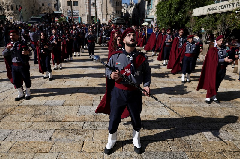 Palestinian scouts parade at Manger Square outside the Church of the Nativity in Bethlehem, in the Israeli-occupied West Bank, on Christmas Eve, December 24, 2025. REUTERS/Ammar Awad