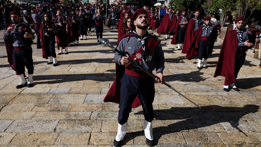 Palestinian scouts parade at Manger Square outside the Church of the Nativity in Bethlehem, in the Israeli-occupied West Bank, on Christmas Eve, December 24, 2025. REUTERS/Ammar Awad