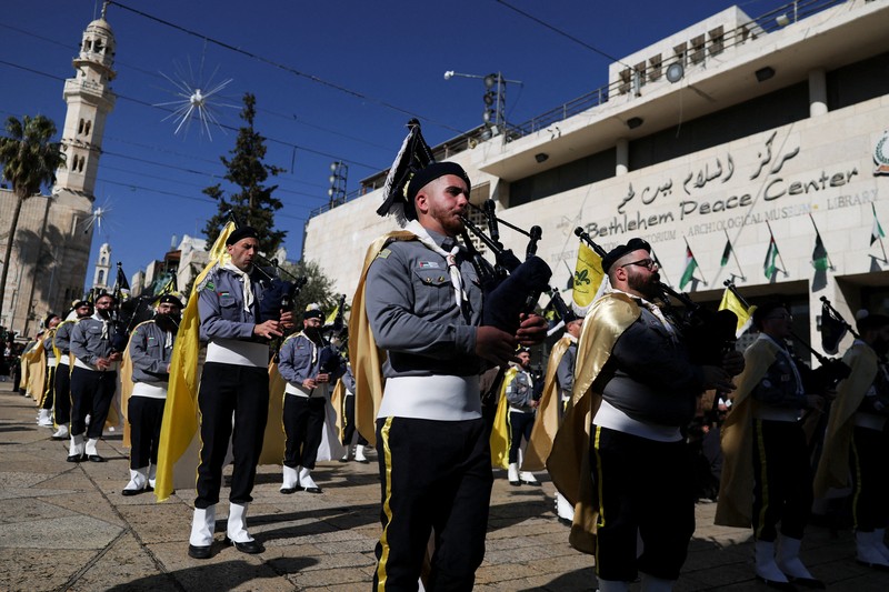 Palestinian scouts parade at Manger Square outside the Church of the Nativity in Bethlehem, in the Israeli-occupied West Bank, on Christmas Eve, December 24, 2025. REUTERS/Ammar Awad