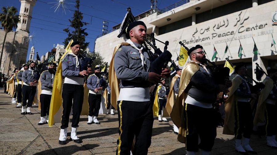 Palestinian scouts parade at Manger Square outside the Church of the Nativity in Bethlehem, in the Israeli-occupied West Bank, on Christmas Eve, December 24, 2025. REUTERS/Ammar Awad