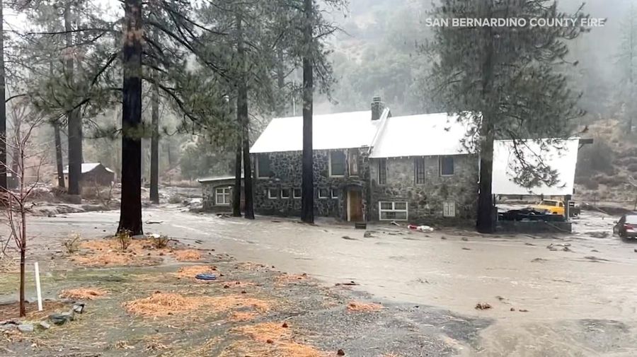 People sit on the roof of a building while they are stranded during floods partially submerging the surrounding area in the aftermath of torrential rains, in San Bernardino County, California, U.S. December 24, 2025 in this screengrab obtained from a social media video. Timothy and the Machine Music via Facebook/via REUTERS  THIS IMAGE HAS BEEN SUPPLIED BY A THIRD PARTY. MANDATORY CREDIT. NO RESALES. NO ARCHIVES.  Verification: Road layout, buildings and utility poles matched file and satellite images Date verified by original file metadata