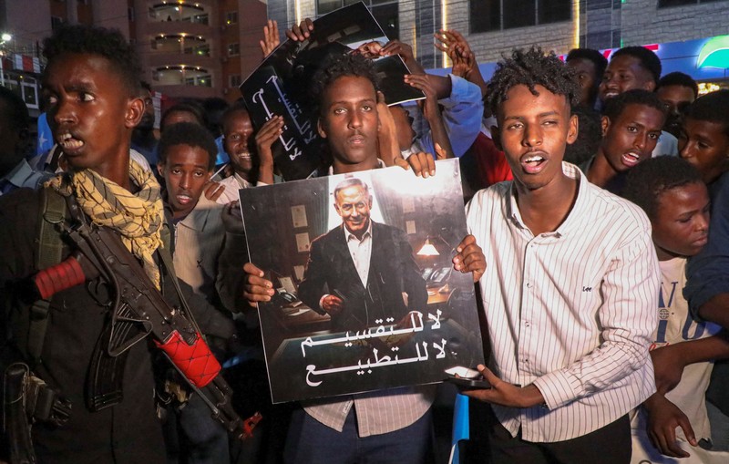 A demonstrator points to the white five‑pointed star on the Somali flag as Somalis attend a demonstration after Israel became the first country to formally recognise the self‑declared Republic of Somaliland as an independent and sovereign state, a decision that could reshape regional dynamics and test Somalia's longstanding opposition to secession, in the Hodan district of Mogadishu, Somalia, December 28, 2025. REUTERS/Feisal Omar