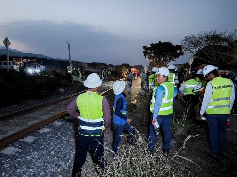 Passengers gather by the rail tracks at the site of a train derailment on the Interoceanic Corridor of the Isthmus of Tehuantepec, a railway line connecting Mexico's Pacific and Gulf coasts, where several passengers were killed and injured near Nizanda, Oaxaca state, Mexico December 28, 2025 in this screen grab obtained from social media video. Video obtained by Reuters/via REUTERS  THIS IMAGE HAS BEEN SUPPLIED BY A THIRD PARTY. NO RESALES. NO ARCHIVES.