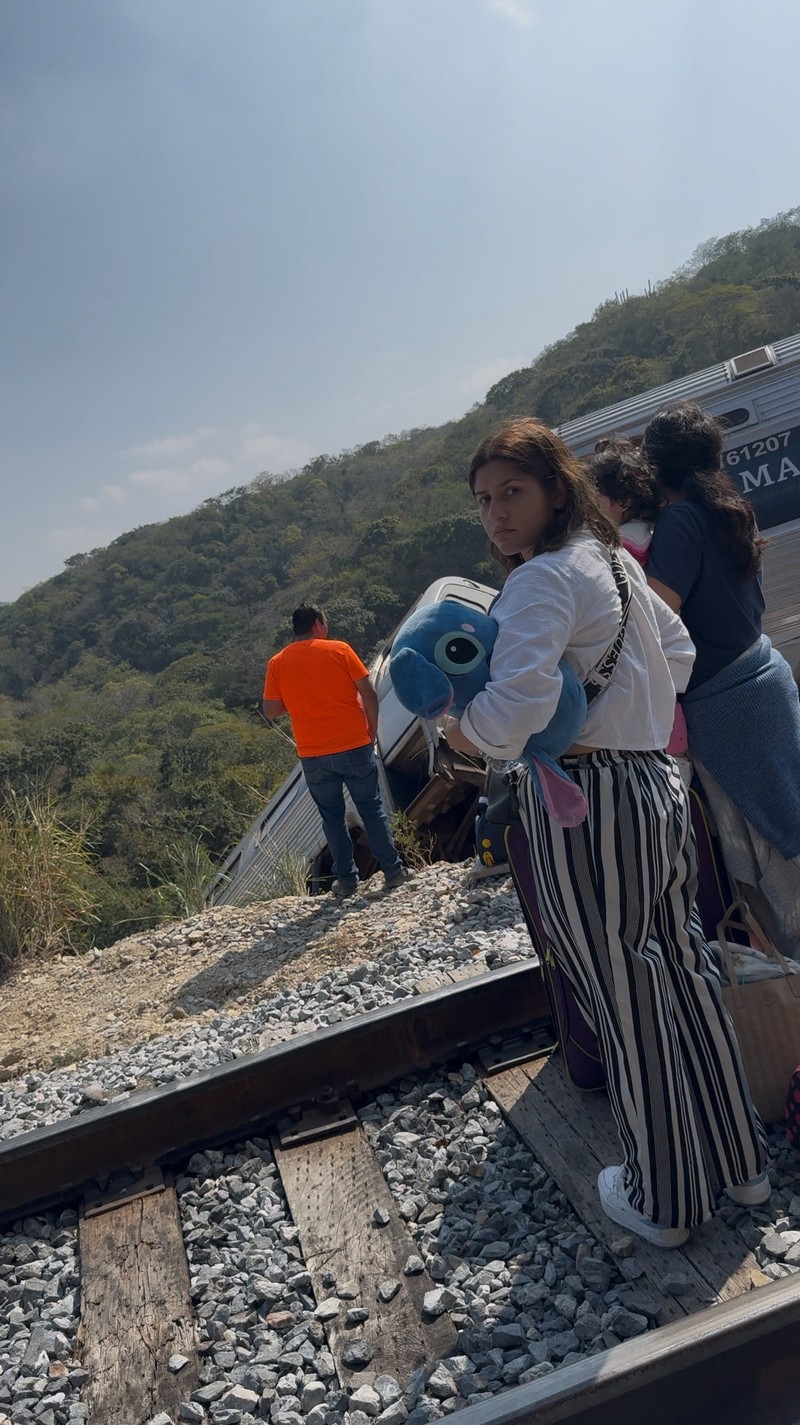 Passengers gather by the rail tracks at the site of a train derailment on the Interoceanic Corridor of the Isthmus of Tehuantepec, a railway line connecting Mexico's Pacific and Gulf coasts, where several passengers were killed and injured near Nizanda, Oaxaca state, Mexico December 28, 2025 in this screen grab obtained from social media video. Video obtained by Reuters/via REUTERS  THIS IMAGE HAS BEEN SUPPLIED BY A THIRD PARTY. NO RESALES. NO ARCHIVES.
