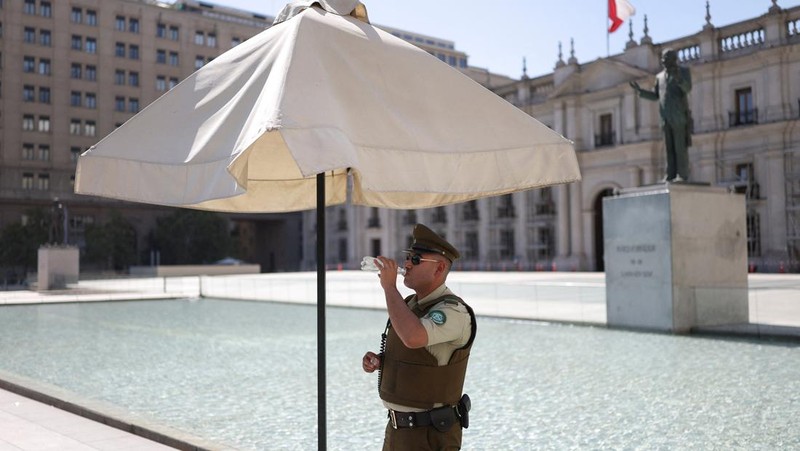 Dua wanita berjalan di bawah sinar matahari, saat gelombang panas di Santiago, Chili, 30 Desember 2025. (REUTERS/Pablo Sanhueza)