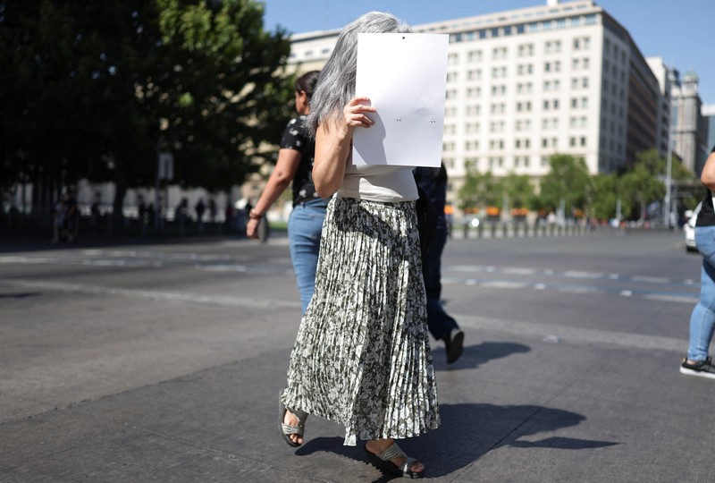 Dua wanita berjalan di bawah sinar matahari, saat gelombang panas di Santiago, Chili, 30 Desember 2025. (REUTERS/Pablo Sanhueza)