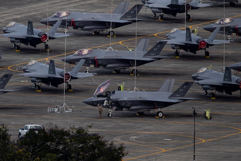 Personnel work on a U.S. Air Force F-35 Lightning II fighter jet parked on the tarmac at the former Roosevelt Roads naval base, amid tensions between the administration of U.S. President Donald Trump and the government of Venezuelan President Nicolas Maduro, in Ceiba, Puerto Rico, January 2, 2026. REUTERS/Eva Marie Uzcategui