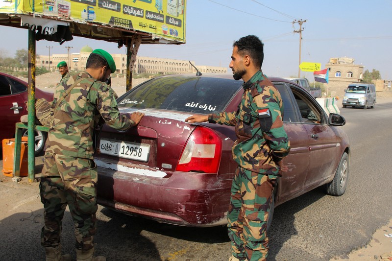 Para petugas polisi berjaga di pos pemeriksaan setelah, menurut koalisi yang didukung Saudi, Aidarous al-Zubaidi, pemimpin Dewan Transisi Selatan Yaman (STC), melarikan diri ke tempat yang tidak diketahui, di Aden, Yaman, 7 Januari 2026. (REUTERS/Fawaz Salman)