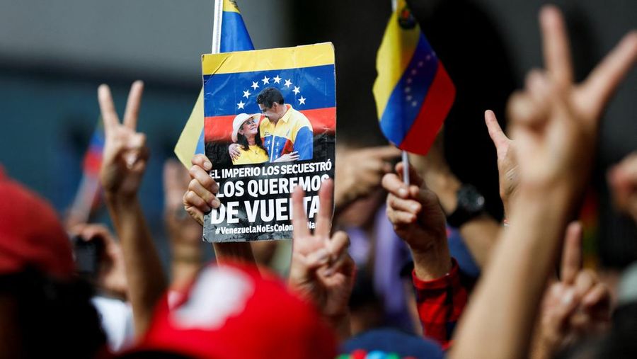 Ribuan warga berkumpul di berbagai wilayah Caracas sambil melambaikan bendera nasional dan memegang foto pasangan itu, menyerukan agar Maduro dan Flores dibebaskan dari tahanan. Aksi massa ini berlangsung di tengah ketegangan politik dan gejolak yang terus bergulir di negara tersebut. (REUTERS/Fausto Torrealba)