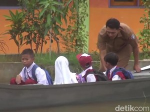 Guru SDN Jelak Catur Jemput Siswa Pakai Perahu Saat Sekolah Kebanjiran