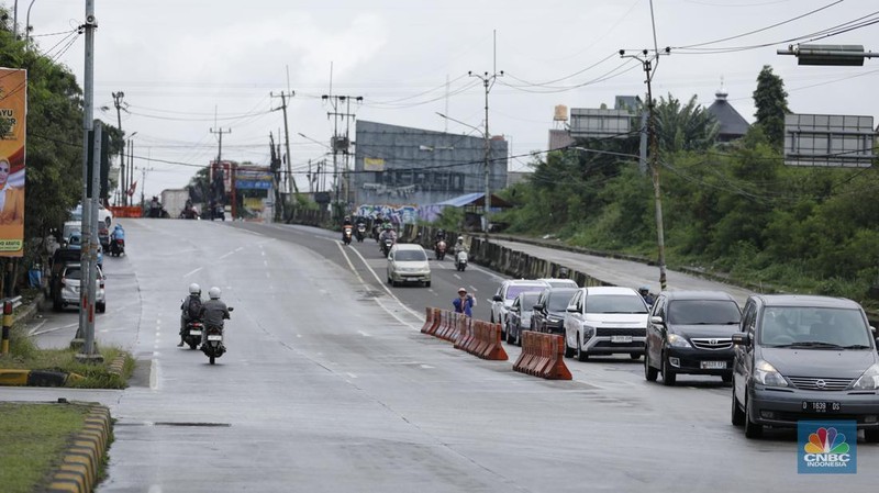 Sejumlah kendaraan melewati Jalan Raya Sawangan, Depok, Jawa Barat, Selasa(13/1/2026). (CNBC Indonesia/Tri Susilo)