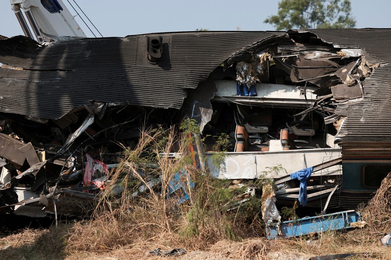 Para petugas bekerja di lokasi kecelakaan kereta api yang terjadi ketika sebuah derek konstruksi roboh dan jatuh menimpa gerbong-gerbongnya, menyebabkan beberapa korban jiwa, di distrik Sikhio, provinsi Nakhon Ratchasima, Thailand, 14 Januari 2026. (REUTERS/Chalinee Thirasupa)