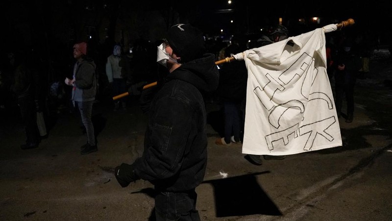 Para pengunjuk rasa berhadapan dan bentrok dengan pihak berwenang di Minneapolis utara dekat lokasi seorang pria ditembak di kaki pada Rabu (14/2/2026). (REUTERS/Ryan Murphy)