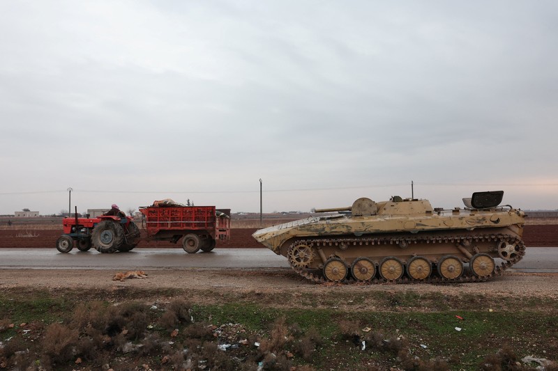 Soldiers in military vehicles on a road to Dayr Hafir east of Aleppo, after a Kurdish-led Syrian Democratic Forces (SDF) withdrawal from the area and its takeover by the Syrian army, in Aleppo, Syria, January 17, 2026. REUTERS/Mahmoud Hassano