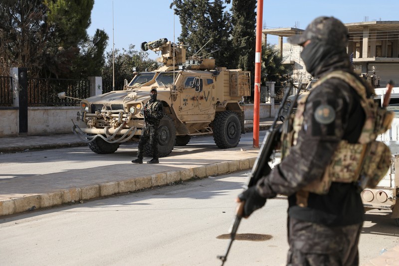 Soldiers in military vehicles on a road to Dayr Hafir east of Aleppo, after a Kurdish-led Syrian Democratic Forces (SDF) withdrawal from the area and its takeover by the Syrian army, in Aleppo, Syria, January 17, 2026. REUTERS/Mahmoud Hassano