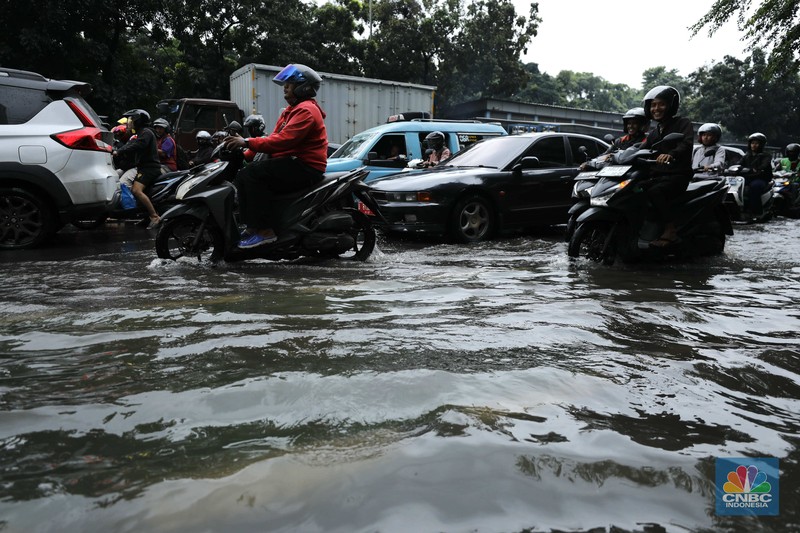 Hujan deras mengguyur Jakarta menyebabkan banjir menggenangi ruas jalan Panjaitan, tepatnya di lajur kiri dari arah Cawang menuju Kebon Nanas, Jakarta, Kamis (22/1/2026). (CNBC Indonesia/Tri Susilo)