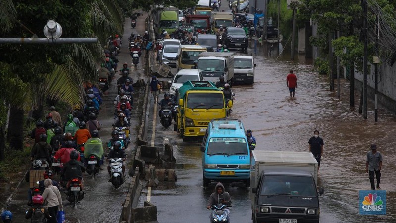 Kendaraan melintas saat banjir melanda ruas Jalan Daan Mogot, Jakarta Barat, Jumat (23/1/2026). (CNBC Indonesia/Tri Susilo)