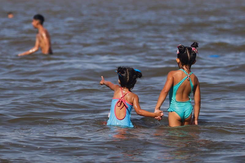 Orang-orang menikmati hari di sungai Rio de la Plata di tengah gelombang panas, di San Isidro, di pinggiran Buenos Aires, Argentina, 27 Januari 2026. (REUTERS/Matias Baglietto)