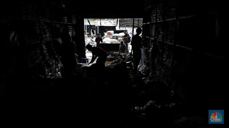 Petugas pemadam kebakaran mendinginkan sisa-sisa api yang masih menyala di Gudang dekorasi dan ruko tekstil di Jalan Pajak Raya, Cipadu, Juramangu Timur, Tangerang Selatan (Tangsel), Senin (2/1/2026). (CNBC Indonesia/Tri Susilo)