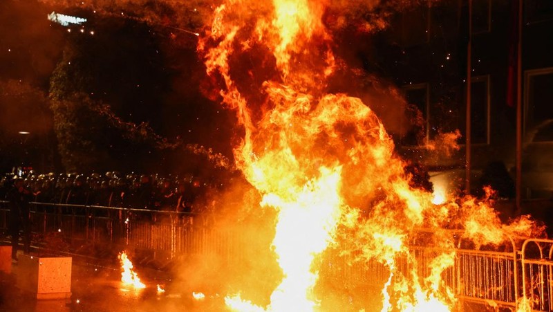 Para petugas polisi bereaksi terhadap bom molotov selama protes anti-pemerintah, yang dipicu oleh penyelidikan korupsi terhadap Wakil Perdana Menteri Belinda Balluku, di depan Gedung Parlemen di Tirana, Albania, 10 Februari 2026. (REUTERS/Florion Goga)