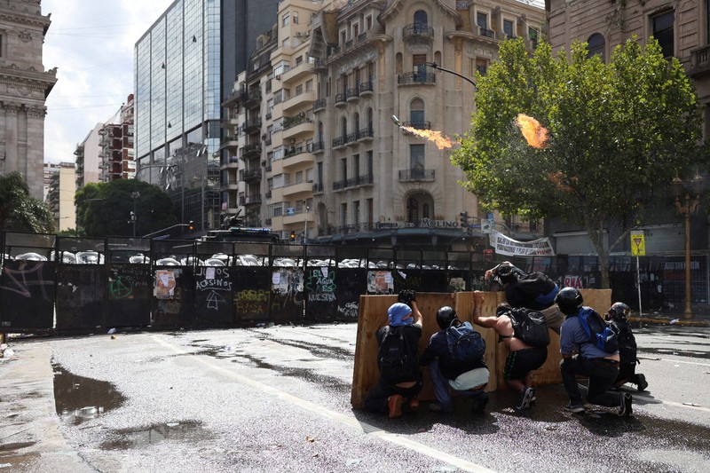 A drone view shows riot police clashing with union members protesting outside the National Congress as members of Argentina's Senate discuss labour reforms proposed by President Javier Milei's libertarian government to attract investment and revive growth, while labour groups say it would roll back workers' rights, in Buenos Aires, Argentina, February 11, 2026. REUTERS/Martin Cossarini