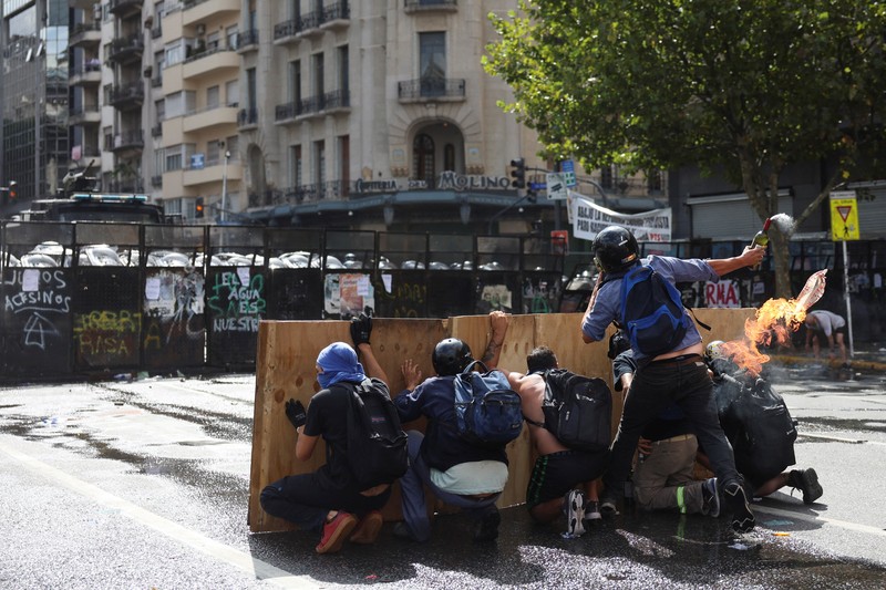 A drone view shows riot police clashing with union members protesting outside the National Congress as members of Argentina's Senate discuss labour reforms proposed by President Javier Milei's libertarian government to attract investment and revive growth, while labour groups say it would roll back workers' rights, in Buenos Aires, Argentina, February 11, 2026. REUTERS/Martin Cossarini