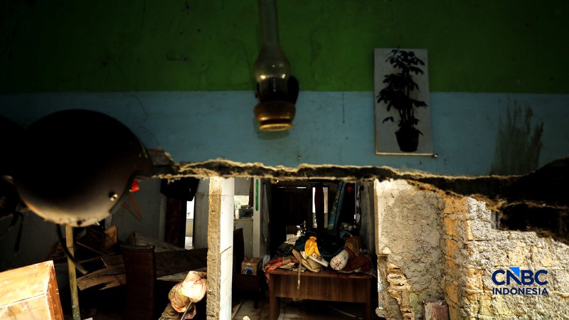 Warga membersihkan properti rumah yang terkena banjir di Kampung Carewed, Desa Cijayanti, Babakan Madang, Kabupaten Bogor, Jawa Barat, Kamis (12/2/2026). (CNBC Indonesia/Tri Susilo)