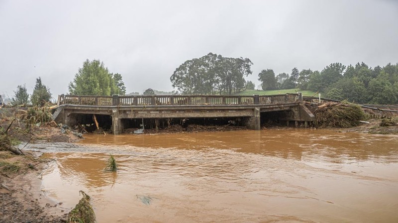 A man retrieves his gear from a utility vehicle that plunged off a collapsed section of road following heavy rain and wild winds in Puketotara, Waikato region, New Zealand, February 14, 2026 in this picture obtained from social media. Wayne Feisst/via REUTERS  THIS IMAGE HAS BEEN SUPPLIED BY A THIRD PARTY. MANDATORY CREDIT. NO RESALES. NO ARCHIVES.     TPX IMAGES OF THE DAY     VERIFICATION: Reuters was able to confirm the location of footage from terrain, road layout, vegetation and bridge seen from file and satellite images. Date of footage was confirmed from file data.