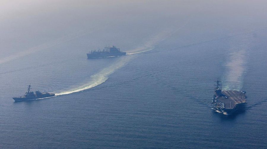 The U.S. Navy's Nimitz-class aircraft carrier USS Abraham Lincoln, Arleigh Burke-class guided-missile destroyer USS Frank E. Petersen Jr. and Lewis and Clark-class dry cargo ship USNS Carl Brashear sail during a photo exercise in the Arabian Sea, February 6, 2026.  U.S. Navy/Mass Communication Specialist 1st Class Jesse Monford/Handout via REUTERS THIS IMAGE HAS BEEN SUPPLIED BY A THIRD PARTY