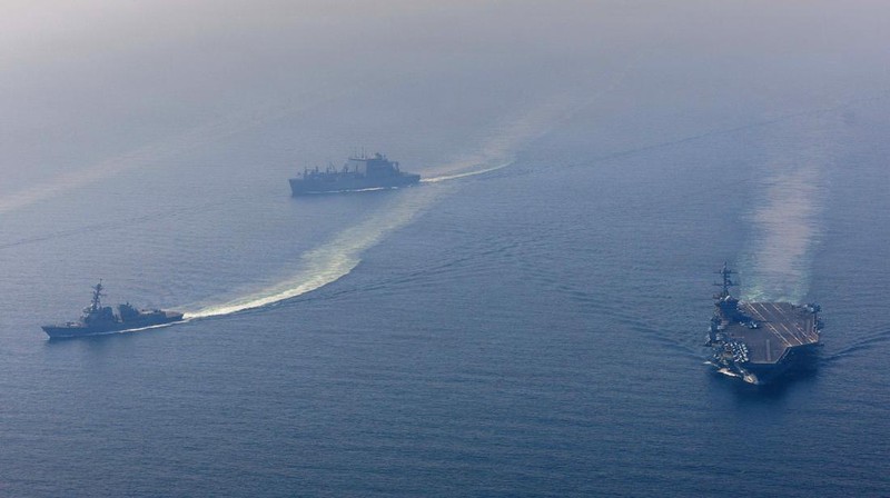 The U.S. Navy's Nimitz-class aircraft carrier USS Abraham Lincoln, Arleigh Burke-class guided-missile destroyer USS Frank E. Petersen Jr. and Lewis and Clark-class dry cargo ship USNS Carl Brashear sail during a photo exercise in the Arabian Sea, February 6, 2026.  U.S. Navy/Mass Communication Specialist 1st Class Jesse Monford/Handout via REUTERS THIS IMAGE HAS BEEN SUPPLIED BY A THIRD PARTY