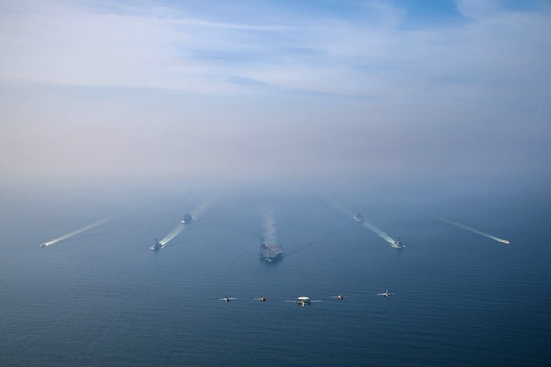The U.S. Navy's Nimitz-class aircraft carrier USS Abraham Lincoln, Arleigh Burke-class guided-missile destroyer USS Frank E. Petersen Jr. and Lewis and Clark-class dry cargo ship USNS Carl Brashear sail during a photo exercise in the Arabian Sea, February 6, 2026.  U.S. Navy/Mass Communication Specialist 1st Class Jesse Monford/Handout via REUTERS THIS IMAGE HAS BEEN SUPPLIED BY A THIRD PARTY
