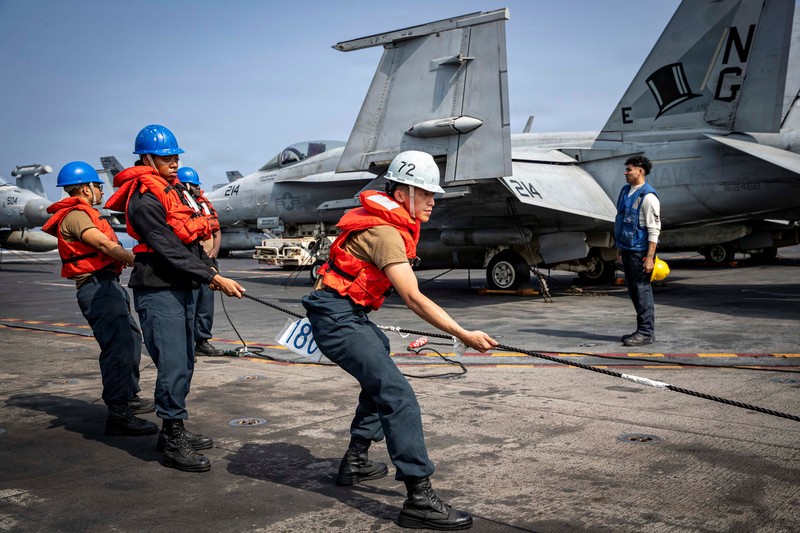 The U.S. Navy's Nimitz-class aircraft carrier USS Abraham Lincoln, Arleigh Burke-class guided-missile destroyer USS Frank E. Petersen Jr. and Lewis and Clark-class dry cargo ship USNS Carl Brashear sail during a photo exercise in the Arabian Sea, February 6, 2026.  U.S. Navy/Mass Communication Specialist 1st Class Jesse Monford/Handout via REUTERS THIS IMAGE HAS BEEN SUPPLIED BY A THIRD PARTY