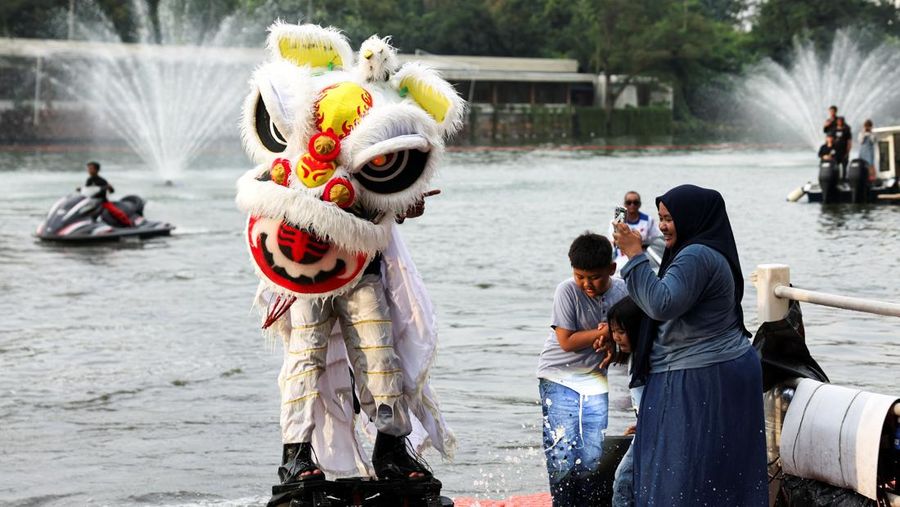 A person uses a flyboard as they perform a lion dance at Senayan Park shopping mall, ahead of the Chinese Lunar New Year, which will welcome the Year of the Horse, in Jakarta, Indonesia, February 14, 2026. REUTERS/Ajeng Dinar Ulfiana     TPX IMAGES OF THE DAY