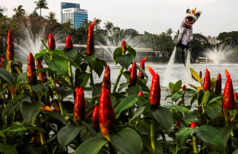 A person uses a flyboard as they perform a lion dance at Senayan Park shopping mall, ahead of the Chinese Lunar New Year, which will welcome the Year of the Horse, in Jakarta, Indonesia, February 14, 2026. REUTERS/Ajeng Dinar Ulfiana     TPX IMAGES OF THE DAY