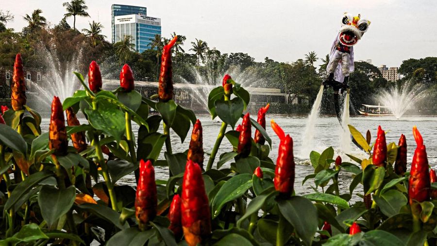 A person uses a flyboard as they perform a lion dance at Senayan Park shopping mall, ahead of the Chinese Lunar New Year, which will welcome the Year of the Horse, in Jakarta, Indonesia, February 14, 2026. REUTERS/Ajeng Dinar Ulfiana     TPX IMAGES OF THE DAY