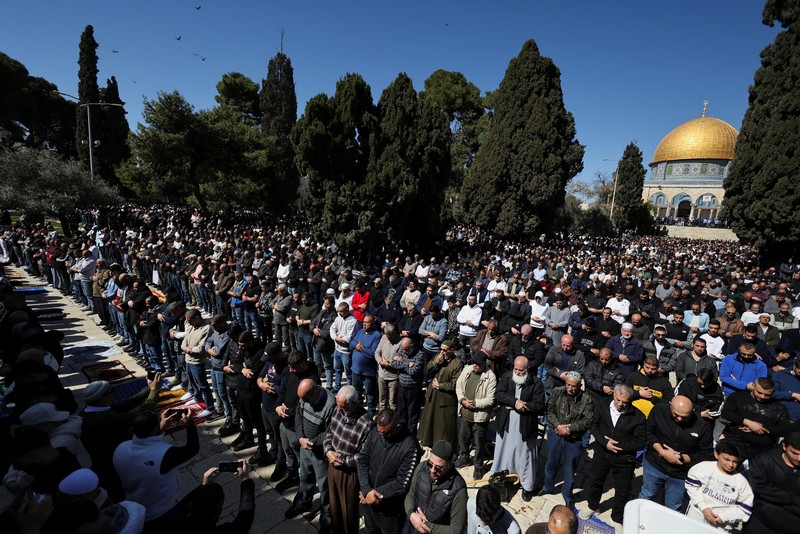 Warga Palestina berbondong-bondong menuju kompleks Al-Aqsa, yang juga dikenal oleh orang Yahudi sebagai Bukit Bait Suci, di Kota Tua Yerusalem, untuk mengikuti salat Jumat pertama selama bulan suci Ramadhan, di dekat pos pemeriksaan Qalandia di Tepi Barat yang diduduki Israel, 20 Februari 2026. (REUTERS/Mohammed Torokman)
