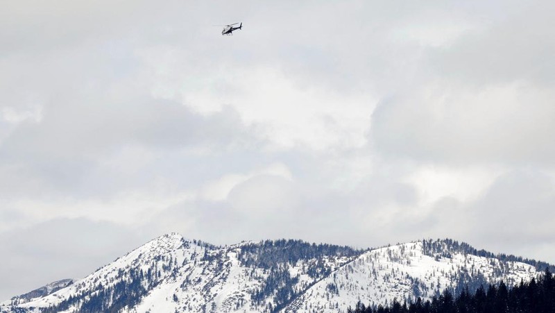 Sebuah kendaraan yang membawa tim penyelamat berdiri di samping rambu 