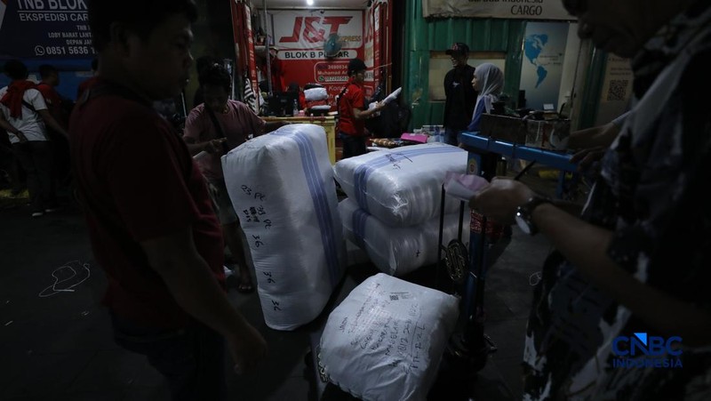 Karyawan menimbang barang yang akan dikirim ke luar pulau jawa di Pasar Tanah Abang, Jakarta, Rabu (25/2/2026). (CNBC Indonesia/Tri Susilo)